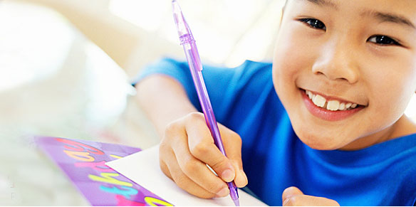 Kid happily writing